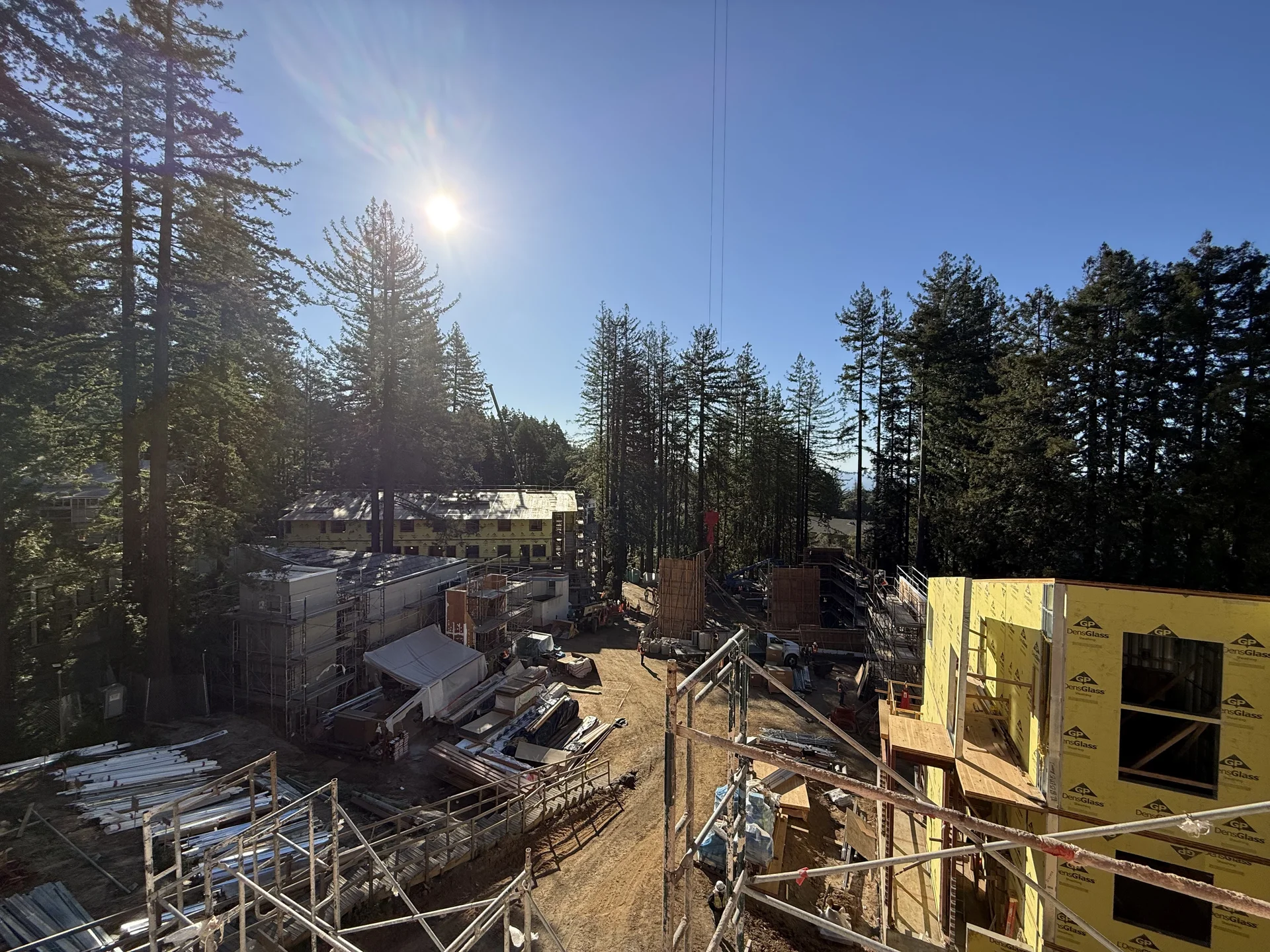 Wood-framed student housing buildings under construction among the redwoods at UC Santa Cruz Kresge College