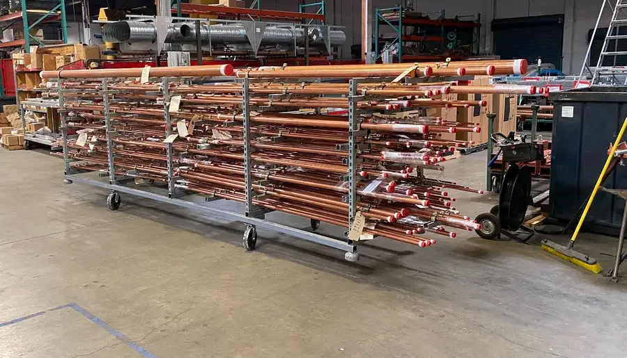 Copper piping spooled and racked by system on shop carts