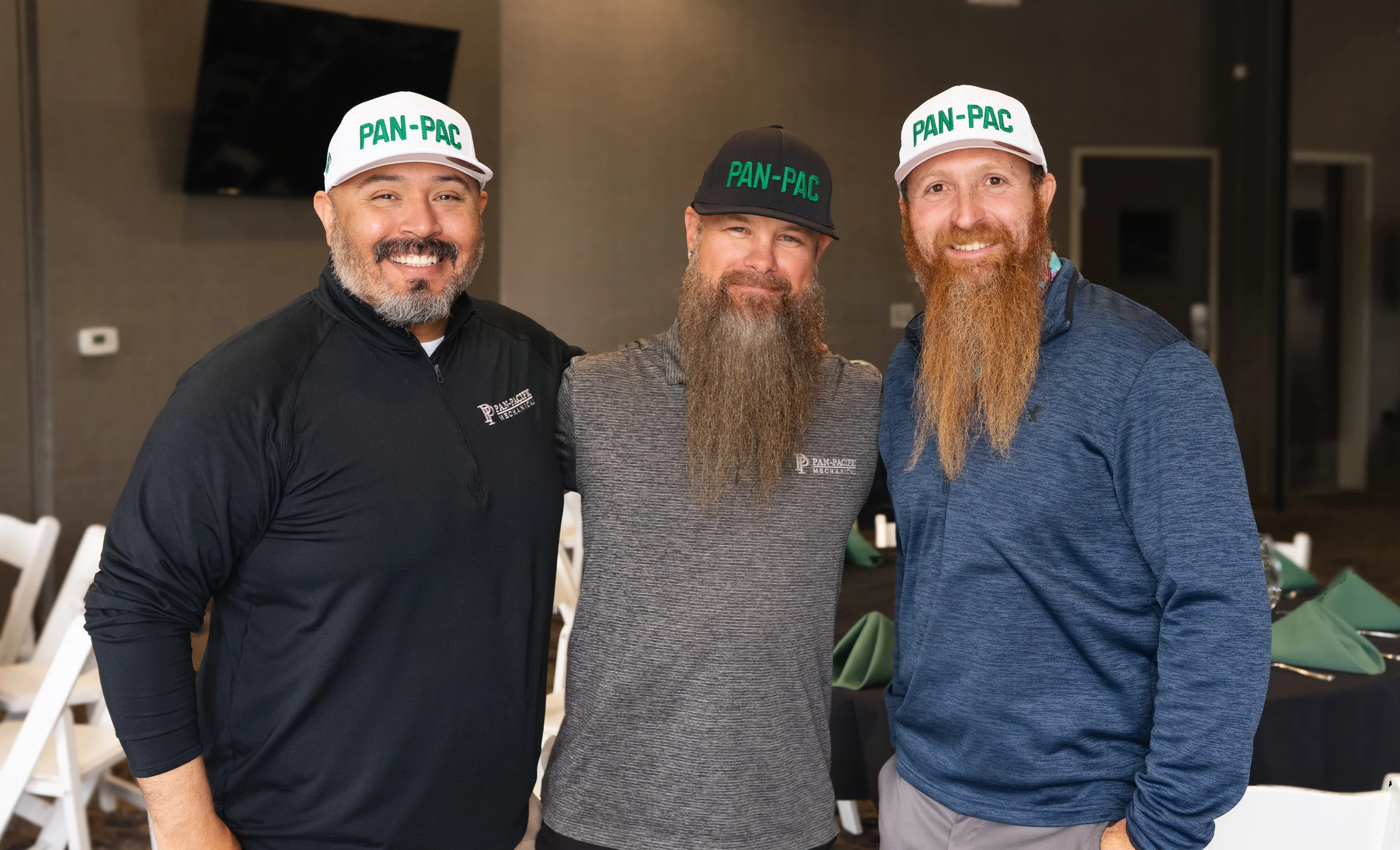 Three Pan-Pacific Mechanical team members at a company event