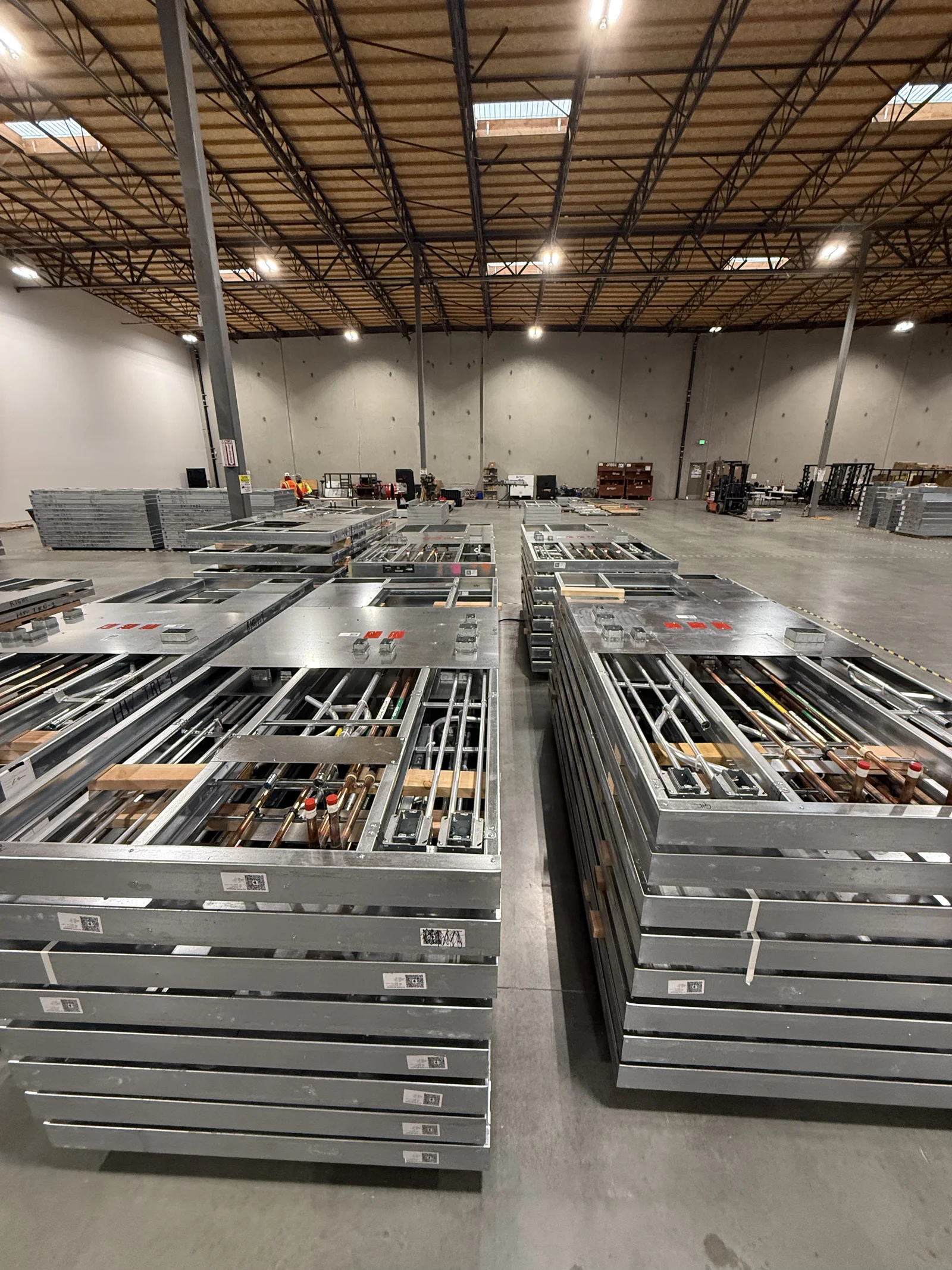 Stacks of prefabricated multi-trade assemblies staged in the Morgan Hill fabrication shop
