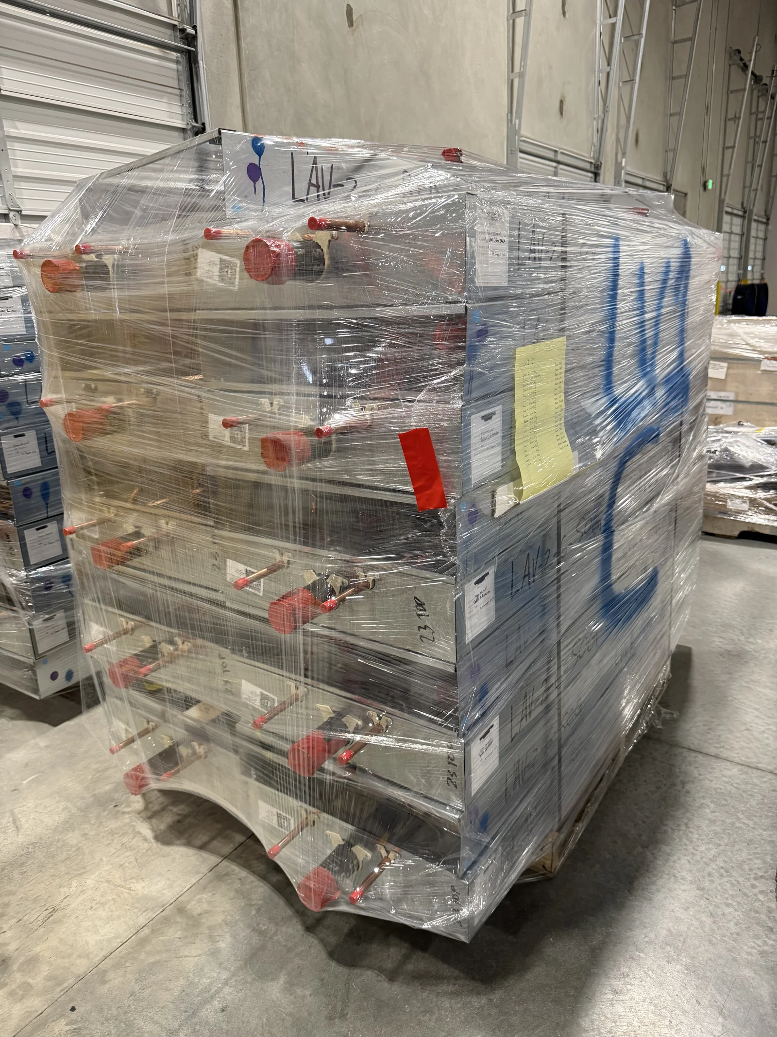 Completed prefabricated assemblies shrink-wrapped on a pallet, ready to ship